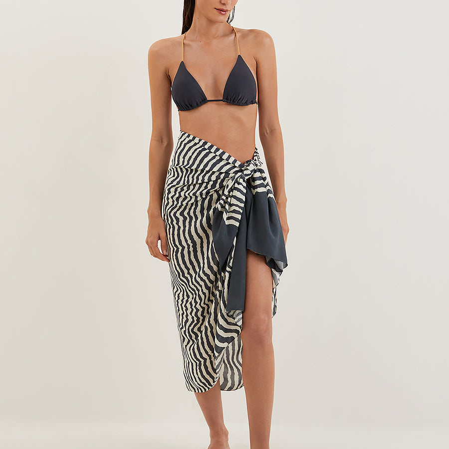 Ravine printed sarong with black bikini, a stylish cover-up option for anyone searching for the best bikini for stretch marks.